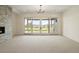 Bright living room with neutral carpet and wide sliding doors to the backyard at 6196 Oxford Peak Ln, Castle Rock, CO 80108