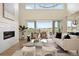 Bright and inviting living room with fireplace, and hardwood floors at 6196 Oxford Peak Ln, Castle Rock, CO 80108