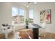 Bright home office with modern desk, large windows, and stylish decor at 6196 Oxford Peak Ln, Castle Rock, CO 80108