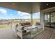 Covered patio with comfortable seating, offering views of the surrounding landscape at 6196 Oxford Peak Ln, Castle Rock, CO 80108