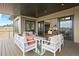 Outdoor patio featuring ample seating, a patterned rug, and views of the neighborhood at 6196 Oxford Peak Ln, Castle Rock, CO 80108