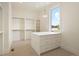Spacious walk-in closet featuring custom shelving, drawers, and ample storage space at 6196 Oxford Peak Ln, Castle Rock, CO 80108