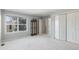 Spacious bedroom featuring large windows for natural light, a display cabinet, and a closet at 10000 E Yale Ave # 7, Denver, CO 80231