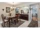 Elegant dining room with a wood table, chandelier, and built-in hutch at 10000 E Yale Ave # 7, Denver, CO 80231