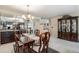 Formal dining room with a large table, chandelier, and built-in hutch at 10000 E Yale Ave # 7, Denver, CO 80231