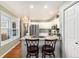 This kitchen features white cabinets, stainless steel appliances, granite countertops, and hardwood floors at 10000 E Yale Ave # 7, Denver, CO 80231