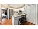 Bright kitchen features white cabinets, stainless steel appliances, granite countertops, and hardwood floors at 10000 E Yale Ave # 7, Denver, CO 80231