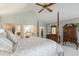 Vaulted ceiling bedroom featuring a four-post bed and ensuite bathroom at 10000 E Yale Ave # 7, Denver, CO 80231