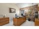 Home office with stone accent wall, built-in desk, and large window for natural light at 10000 E Yale Ave # 7, Denver, CO 80231