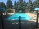 Community pool surrounded by lounge chairs and manicured landscaping. No Diving sign visible at 10000 E Yale Ave # 7, Denver, CO 80231