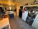 Eat-in kitchen area featuring stainless steel washer and dryer in a nearby closet at 2874 Rose Hill St, Strasburg, CO 80136