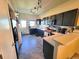 Kitchen features a sink, range and a refrigerator next to the back door at 2874 Rose Hill St, Strasburg, CO 80136