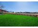 Expansive green backyard with a wooden fence and community field beyond, perfect for outdoor activities at 2954 E 108Th Dr, Northglenn, CO 80233