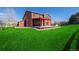 Well-maintained backyard featuring a covered patio, lush green lawn, and inviting outdoor space at 2954 E 108Th Dr, Northglenn, CO 80233