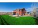 Beautiful backyard with a patio, hot tub, and green lawn, perfect for entertaining or relaxing outdoors at 2954 E 108Th Dr, Northglenn, CO 80233