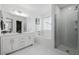 Bright bathroom features a double vanity, separate tub, and modern shower with glass doors at 2954 E 108Th Dr, Northglenn, CO 80233