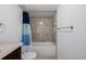 Bathroom featuring a vanity, tub-shower combination with a modern shower head and neutral tiling at 2954 E 108Th Dr, Northglenn, CO 80233