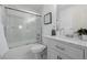 Bathroom with a marble-top vanity, sliding glass door shower, and modern fixtures at 2954 E 108Th Dr, Northglenn, CO 80233