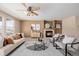 Cozy living room featuring a fireplace, plush seating, stylish decor, and a ceiling fan at 2954 E 108Th Dr, Northglenn, CO 80233