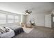 Bright main bedroom featuring a ceiling fan, sitting area, and natural light at 2954 E 108Th Dr, Northglenn, CO 80233