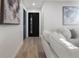 Light and bright hallway with modern black door at 4355 Ingalls St, Wheat Ridge, CO 80033