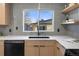 Modern kitchen with light wood cabinets, gray tile backsplash, and stainless steel appliances at 4355 Ingalls St, Wheat Ridge, CO 80033