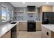 Modern kitchen with gray tile backsplash and light wood cabinets at 4355 Ingalls St, Wheat Ridge, CO 80033