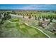 Panoramic aerial view of a golf course community showcasing the lush green fairways and stunning mountain views at 23312 E Chestnut Pl, Aurora, CO 80016