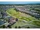 Panoramic aerial shot of homes nestled next to a lush golf course, showcasing the neighborhood layout and landscaping at 23312 E Chestnut Pl, Aurora, CO 80016