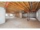 Unfinished basement with exposed wood beams and ductwork, offering potential for customization at 23312 E Chestnut Pl, Aurora, CO 80016