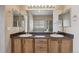 Bathroom featuring double sinks, framed mirrors, and vanity lighting at 23312 E Chestnut Pl, Aurora, CO 80016