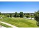 Picturesque golf course view with a serene pond and lush green fairways on a clear day at 23312 E Chestnut Pl, Aurora, CO 80016