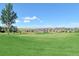 Scenic view of the community golf course featuring rolling greens, lush fairways, and surrounding houses at 23312 E Chestnut Pl, Aurora, CO 80016