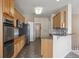 Kitchen with granite countertops, stainless steel appliances, and natural wood cabinets at 23312 E Chestnut Pl, Aurora, CO 80016