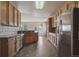 Well-equipped kitchen with stainless steel appliances, wooden cabinetry, and easy access to dining area at 23312 E Chestnut Pl, Aurora, CO 80016