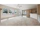 Spacious living room with an open layout, large windows offering scenic views and access to the kitchen at 23312 E Chestnut Pl, Aurora, CO 80016