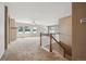 Bright and airy living room with a view of the outdoors through large windows and staircase access at 23312 E Chestnut Pl, Aurora, CO 80016