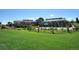 Exterior view of the clubhouse pool surrounded by a fenced area with green grass at 23312 E Chestnut Pl, Aurora, CO 80016