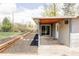 Spacious backyard area with a patio, mulch, and a well-maintained lawn at 4209 S Bannock St, Englewood, CO 80110