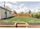 Large backyard with lush lawn, privacy fence, and mulch beds at 4209 S Bannock St, Englewood, CO 80110