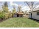 Large backyard area with green grass and two outbuildings at 4209 S Bannock St, Englewood, CO 80110