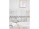 Close-up of the bathtub with beautiful neutral tile and trim and a modern faucet at 4209 S Bannock St, Englewood, CO 80110