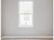 View of the bedroom's neutral wall color and beige carpet and a large window at 4209 S Bannock St, Englewood, CO 80110