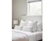 Cozy bedroom features a white bed and plenty of natural light from a window at 4209 S Bannock St, Englewood, CO 80110