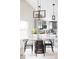 Cozy dining area near the kitchen featuring a unique table, contemporary lighting, and white walls at 4209 S Bannock St, Englewood, CO 80110