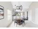 Dining area featuring a round table, unique lighting, and views into the adjacent kitchen at 4209 S Bannock St, Englewood, CO 80110