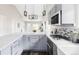 Bright kitchen has stainless appliances, gray cabinets, stone countertops, and modern lighting at 4209 S Bannock St, Englewood, CO 80110