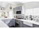 This modern kitchen features stainless steel appliances, gray cabinets, and tile backsplash at 4209 S Bannock St, Englewood, CO 80110