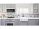 Updated kitchen offers stainless steel appliances, stylish cabinets, and mosaic backsplash at 4209 S Bannock St, Englewood, CO 80110