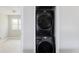 Stacked washer and dryer in a laundry room with neutral wall color at 4209 S Bannock St, Englewood, CO 80110